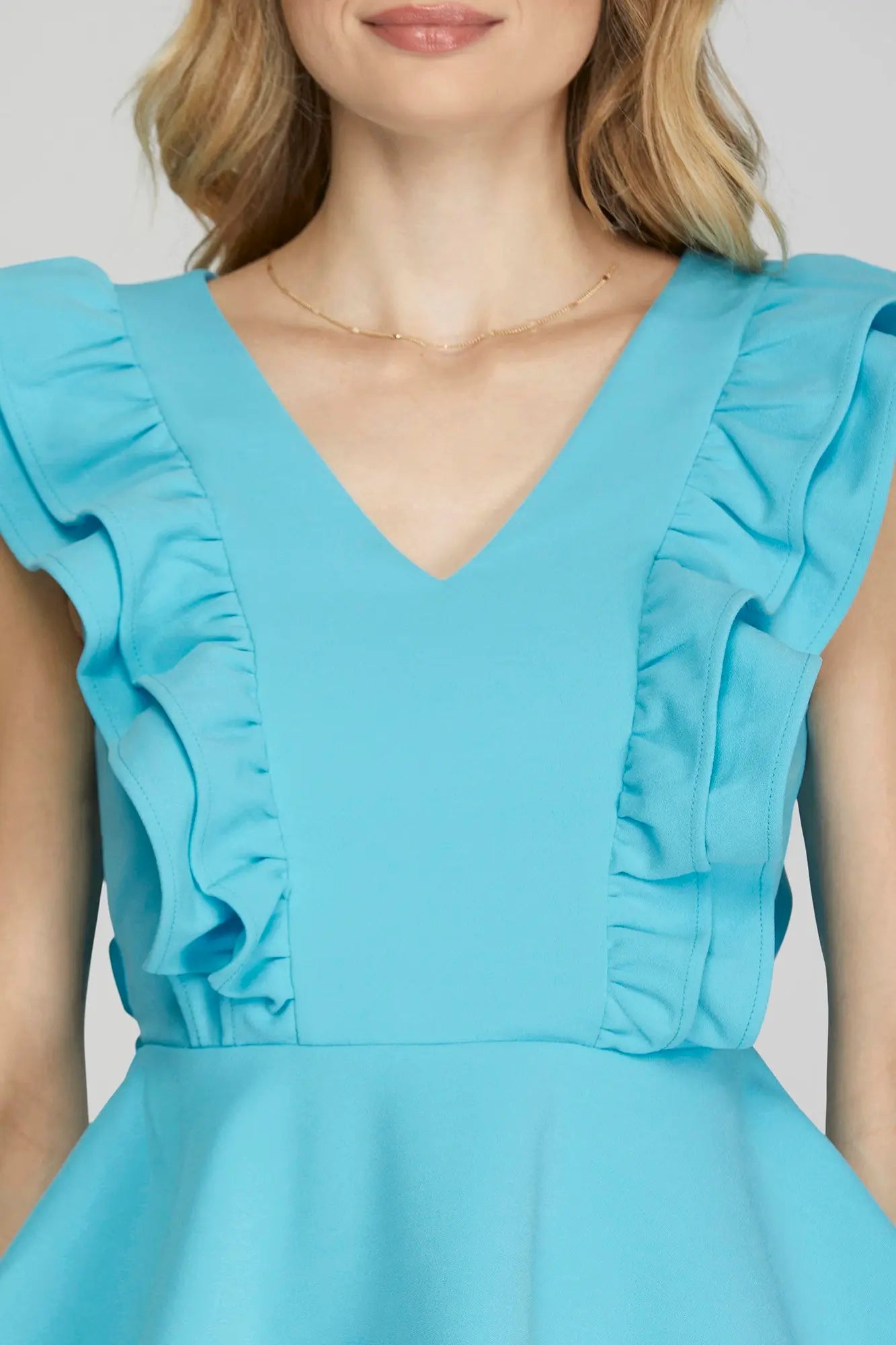 SLEEVELESS RUFFLED PEPLUM TOP